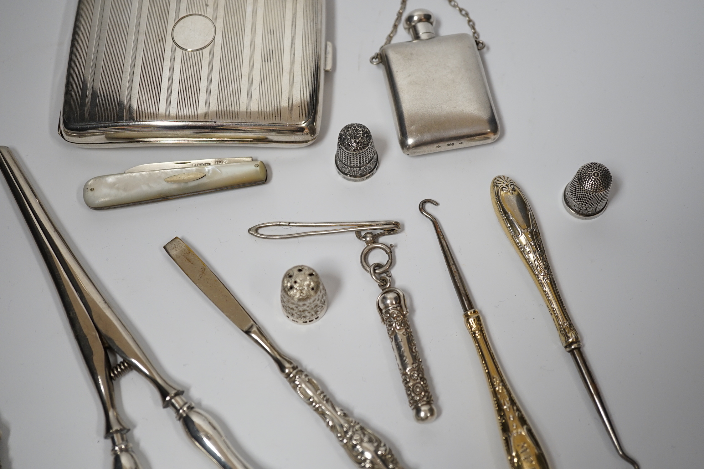 A George V silver cigarette case, Adie Bros. Birmingham, 1929, two silver and two sterling mounted button hooks and seven other items including propelling pencil in case, fruit knife and Italian 800 standard scent flask.